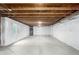Unfinished basement with a concrete floor, white walls and visible ceiling structure at 9791 Dunning Cir, Highlands Ranch, CO 80126