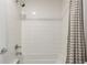 Clean, bright bathroom features a white tiled shower-tub combination and a stylish shower curtain at 9791 Dunning Cir, Highlands Ranch, CO 80126