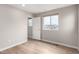 Neutral bedroom featuring hardwood-style floors and a window; the doorway is visible at 9791 Dunning Cir, Highlands Ranch, CO 80126