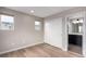 Bright bedroom with wood-look floors, two windows and a closet located just off the bathroom at 9791 Dunning Cir, Highlands Ranch, CO 80126