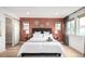 Bright bedroom with a large bed, sleek floors, and natural lighting from the sizable windows at 9791 Dunning Cir, Highlands Ranch, CO 80126