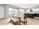 Bright dining area with wooden table, bench seating, and modern decor next to the updated kitchen area at 9791 Dunning Cir, Highlands Ranch, CO 80126