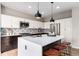 Modern kitchen features a quartz countertop island, stylish backsplash, and stainless steel appliances at 9791 Dunning Cir, Highlands Ranch, CO 80126