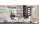 Inviting living room featuring wood floors, comfortable blue seating, and contemporary decor at 9791 Dunning Cir, Highlands Ranch, CO 80126