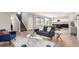 Open-concept living area with wood floors, ample seating, and easy access to the kitchen and stairway at 9791 Dunning Cir, Highlands Ranch, CO 80126