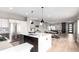 Open-concept layout integrates the kitchen with quartz countertop island and connected living and dining areas at 9791 Dunning Cir, Highlands Ranch, CO 80126