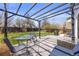 The backyard offers a patio area with pergola, seating, and a spacious lawn at 11753 Elizabeth Cir, Thornton, CO 80233