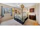 Relaxing bedroom boasts a four-poster bed, ceiling fan, and ample natural light from the window at 11753 Elizabeth Cir, Thornton, CO 80233