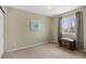 Calm bedroom features a window, trunk, and neutral tones, offering a tranquil atmosphere at 11753 Elizabeth Cir, Thornton, CO 80233