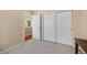 Comfortable bedroom features a large closet, carpeted floors, and a door to the hallway at 11753 Elizabeth Cir, Thornton, CO 80233