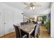 Dining room with a wooden floor, large mirror, and a ceiling fan at 11753 Elizabeth Cir, Thornton, CO 80233