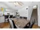 Open dining room features a ceiling fan and easy access to both the kitchen and stairs at 11753 Elizabeth Cir, Thornton, CO 80233