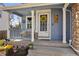 Inviting front porch with a charming yellow wreath and cozy seating area at 11753 Elizabeth Cir, Thornton, CO 80233