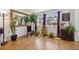 Bright sitting area with wood floors, large mirror and lots of natural light from large window at 11753 Elizabeth Cir, Thornton, CO 80233