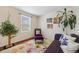 Cozy living area featuring vibrant floral rug, reading chair, and plants for a relaxing ambiance at 11753 Elizabeth Cir, Thornton, CO 80233