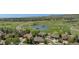 Aerial view of suburban homes near a golf course and pond, offering scenic views and a tranquil community setting at 11422 W Cooper Ave, Littleton, CO 80127