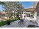 A beautifully landscaped backyard with mature trees and covered patio at 11422 W Cooper Ave, Littleton, CO 80127