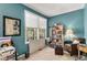 Cozy bedroom featuring neutral walls, a large window and a comfortable sitting chair at 11422 W Cooper Ave, Littleton, CO 80127
