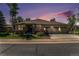 Charming single-story home with a three-car garage and stone accents set against a vibrant sunset sky at 11422 W Cooper Ave, Littleton, CO 80127