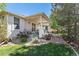 Inviting home exterior with a covered patio, beautiful landscaping, and a well-maintained lawn at 11422 W Cooper Ave, Littleton, CO 80127