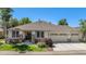 Well-maintained home featuring a three-car garage, stone accents, tidy landscaping, and a charming covered entry at 11422 W Cooper Ave, Littleton, CO 80127