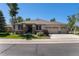 Charming single-story home with a three-car garage, stone accents, and lush green lawn at 11422 W Cooper Ave, Littleton, CO 80127