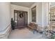Inviting front porch featuring a cozy bench, stylish wreath, and beautiful stone detailing at 11422 W Cooper Ave, Littleton, CO 80127