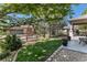 Well-maintained front yard with lush lawn, charming fence, and view of the home's exterior at 11422 W Cooper Ave, Littleton, CO 80127
