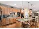 Bright kitchen boasts granite countertops, stainless steel appliances, wood floors, and a breakfast bar at 11422 W Cooper Ave, Littleton, CO 80127