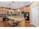 Bright kitchen boasts granite countertops, stainless steel appliances, and wood floors with two bar stools at 11422 W Cooper Ave, Littleton, CO 80127