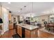 Bright kitchen featuring granite countertops, stainless steel appliances, and an island overlooking the living room at 11422 W Cooper Ave, Littleton, CO 80127
