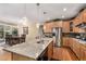 Bright kitchen boasts granite countertops, stainless steel appliances, and wood floors overlooking the eat in kitchen at 11422 W Cooper Ave, Littleton, CO 80127