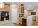 Kitchenette area with oak cabinets, granite countertops, built-in oven, and a wine cooler at 11422 W Cooper Ave, Littleton, CO 80127