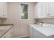 Convenient laundry room featuring a laundry sink, window and a new washer and dryer at 11422 W Cooper Ave, Littleton, CO 80127