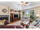 Inviting living room with a cozy fireplace, large windows, and stylish decor at 11422 W Cooper Ave, Littleton, CO 80127