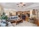Spacious living area with hardwood floors and open concept floorplan connecting to the dining and kitchen areas at 11422 W Cooper Ave, Littleton, CO 80127