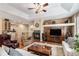 Open living space with a fireplace, hardwood floors, and seamless transition to the kitchen area at 11422 W Cooper Ave, Littleton, CO 80127