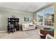 Comfortable office/living room features a comfortable couch, desk and large windows at 11422 W Cooper Ave, Littleton, CO 80127