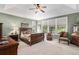 This well-lit main bedroom is adorned with a ceiling fan and is accentuated by many windows at 11422 W Cooper Ave, Littleton, CO 80127