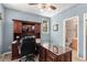 This office has a large dark wood executive desk, a ceiling fan, and access to a bathroom at 11422 W Cooper Ave, Littleton, CO 80127