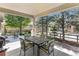 Covered patio with outdoor dining set, offering a serene space for relaxation and entertaining at 11422 W Cooper Ave, Littleton, CO 80127
