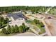 Aerial view of equestrian center with multiple barns, stables, and riding rings amid lush greenery at 30886 County Road 17/21, Elizabeth, CO 80107