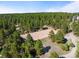 Aerial view of a secluded equestrian sand arena bordered by a dense forest and trees at 30886 County Road 17/21, Elizabeth, CO 80107