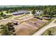 Aerial view of a horse ranch featuring multiple barns, stables, and outdoor riding areas at 30886 County Road 17/21, Elizabeth, CO 80107