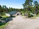 Large barn with a green roof and attached white fenced paddock provides ample space and shelter at 30886 County Road 17/21, Elizabeth, CO 80107