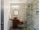 Modern bathroom featuring a unique wood vanity, stylish mirror, and a glass-enclosed shower with stone accents at 30886 County Road 17/21, Elizabeth, CO 80107