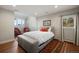 Cozy bedroom with hardwood floors, a comfortable bed, and ample natural light from the bright windows at 30886 County Road 17/21, Elizabeth, CO 80107