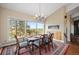 Dining room featuring large windows with mountain views, a fireplace, and a modern chandelier at 30886 County Road 17/21, Elizabeth, CO 80107