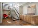 Bright entryway featuring hardwood floors, open stairs, and built-in cabinets at 30886 County Road 17/21, Elizabeth, CO 80107
