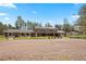 Sprawling single story home with brick exterior and three dormer windows under a blue sky at 30886 County Road 17/21, Elizabeth, CO 80107